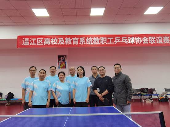 A group of people standing in front of a ping pong tableDescription automatically generated
